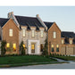 European and modern cottage style of architecture custom home with front lawn and landscaping.