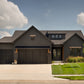 A black front exterior of a custom home built in the modern farmhouse style of architecture.