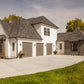 Garage side of a custom home in the European and cottage style of architecture.