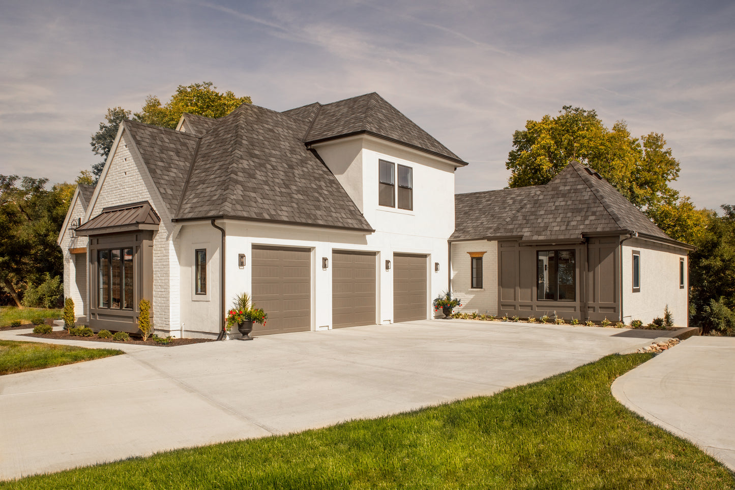 Garage side of a custom home in the European and cottage style of architecture.